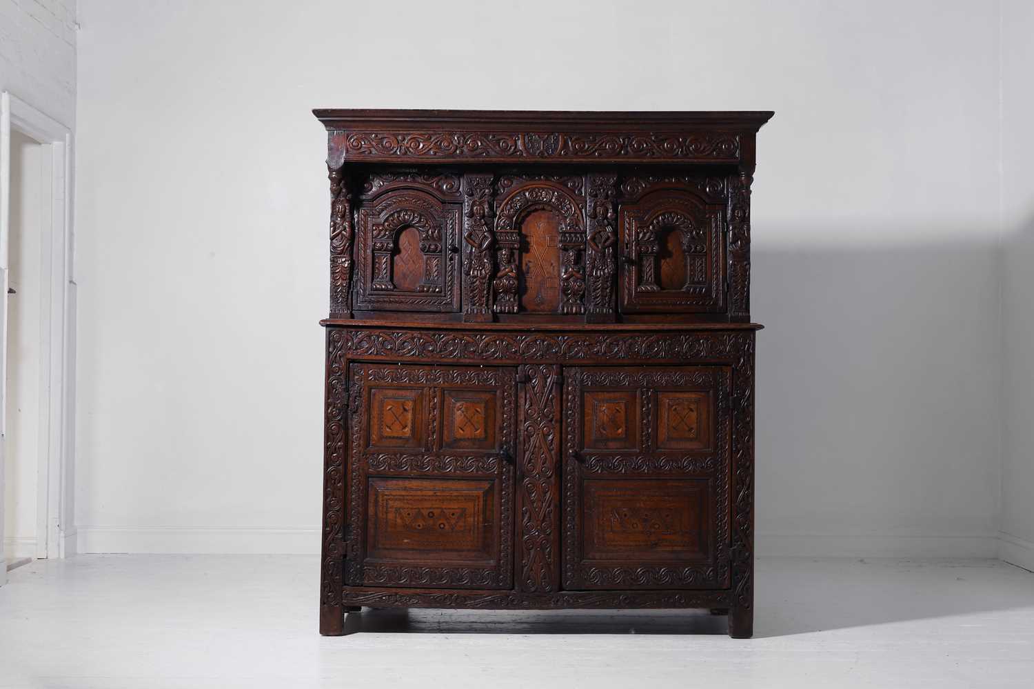 Lot 13 - A carved oak court cupboard
