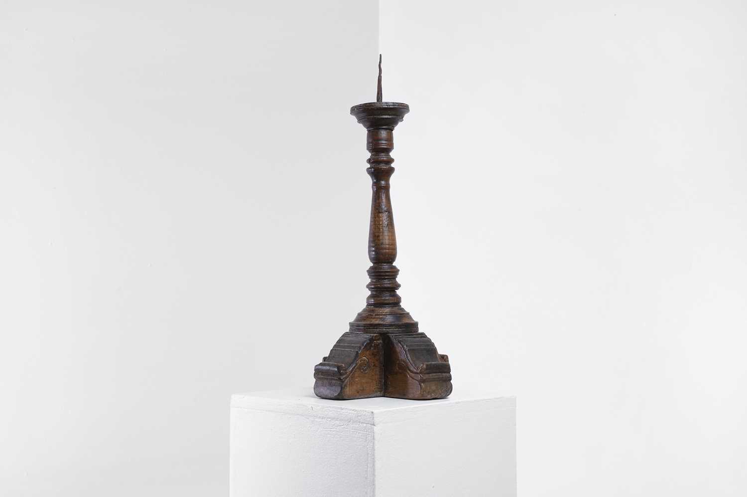 Lot 18 - A walnut pricket candlestick