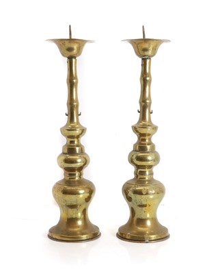Lot 137 - A pair of Chinese brass pricket candlesticks