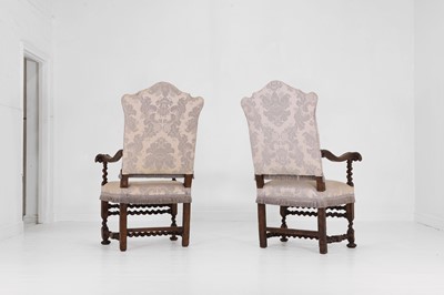 Lot 27 - A pair of large carved-walnut open armchairs