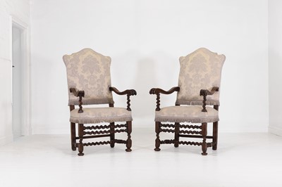 Lot 27 - A pair of large carved-walnut open armchairs