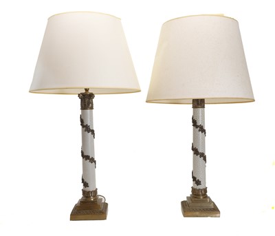 Lot 557 - A pair of brass column table lamps