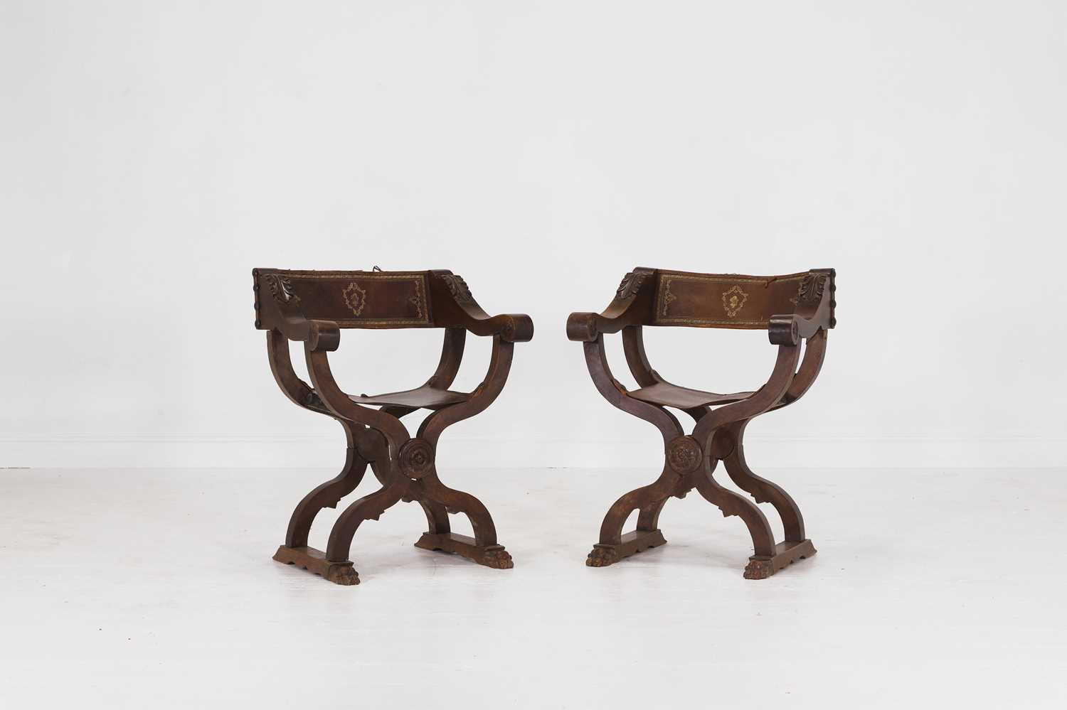 Lot 2 - A pair of Renaissance-style carved walnut Savonarola chairs