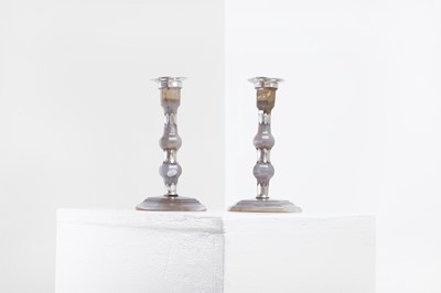 Lot 128 - A pair of silver-mounted agate candlesticks