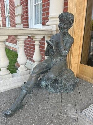 Lot 464 - A modern bronzed figure of a seated boy
