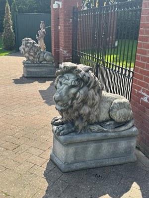 Lot 462 - A pair of composite recumbent lions