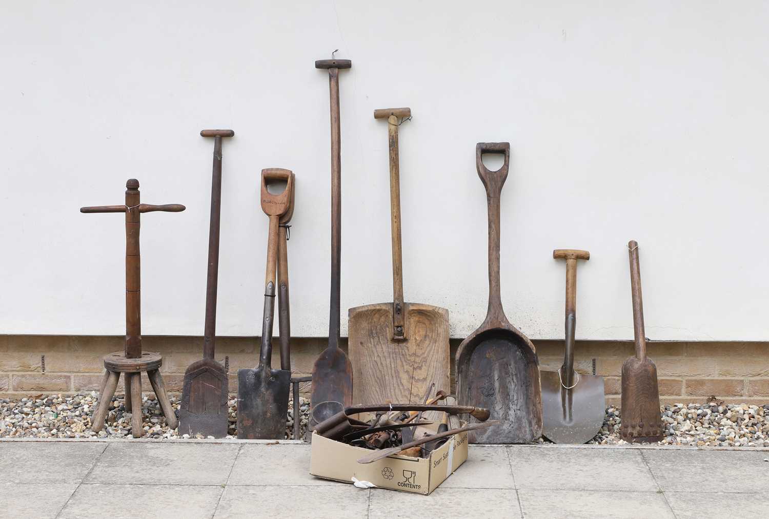 Lot 482 - A collection of grain shovels, two spades and a wash dolly
