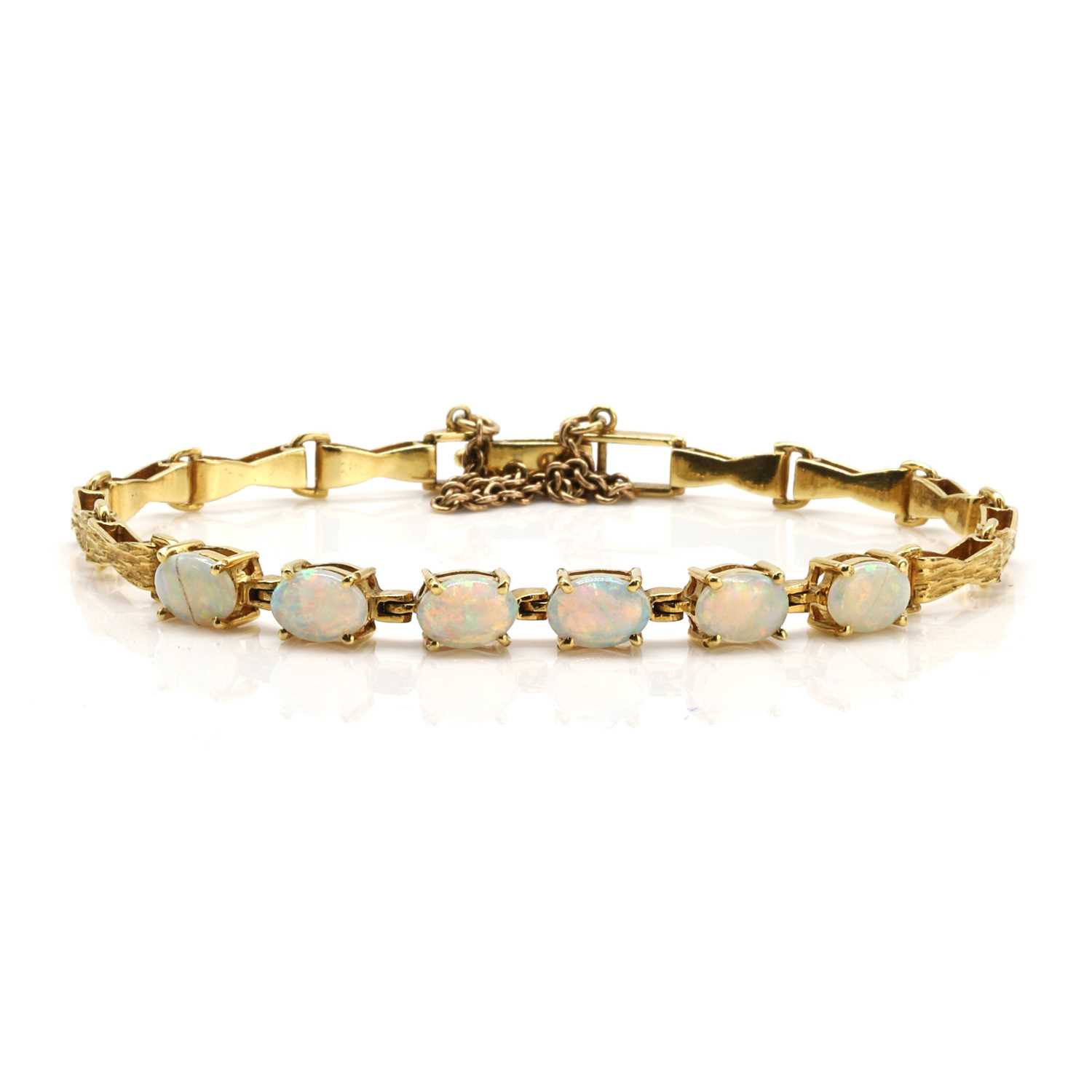 Lot 221 - An opal cabochon link bracelet