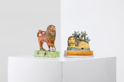Lot 433 - Two Staffordshire pottery lions