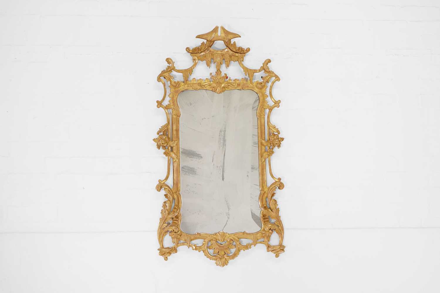 Lot 492 - A George III-style carved giltwood pier mirror