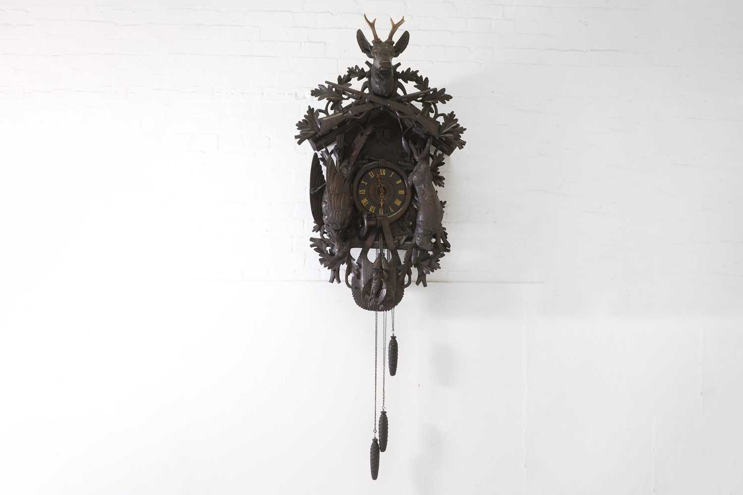 Lot 235 - A Black Forest carved wooden cuckoo clock