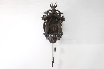 Lot 120 - A Black Forest carved wooden cuckoo clock