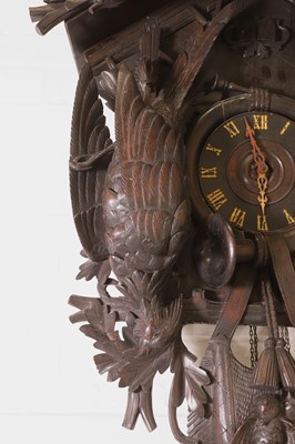 Lot 235 - A Black Forest carved wooden cuckoo clock