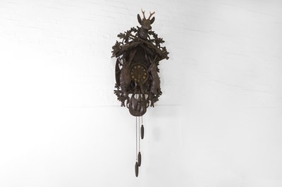 Lot 235 - A Black Forest carved wooden cuckoo clock