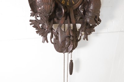 Lot 235 - A Black Forest carved wooden cuckoo clock
