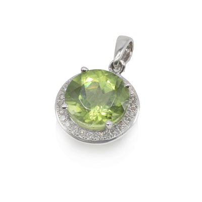 Lot 183 - An 18ct white gold peridot and diamond pendant