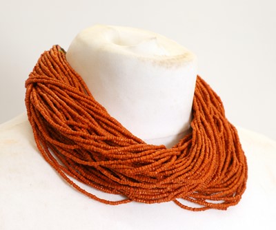 Lot 428 - A Naga red glass multi-strand beaded necklace