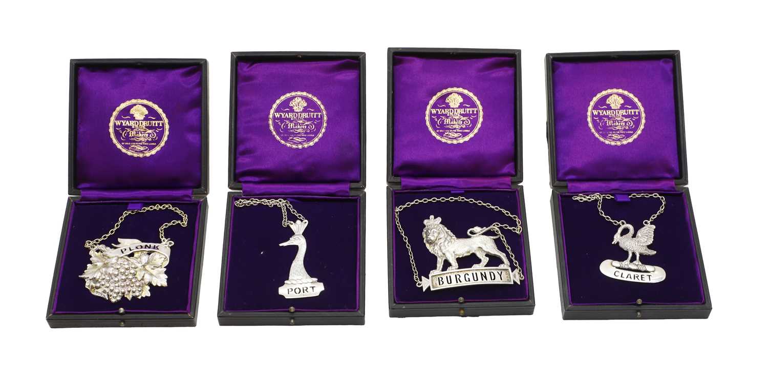 Lot 27 - A group of four silver decanter labels