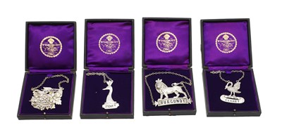 Lot 27 - A group of four silver decanter labels
