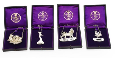 Lot 27 - A group of four silver decanter labels