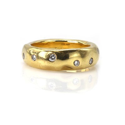Lot 105 - An 18ct gold diamond set band ring