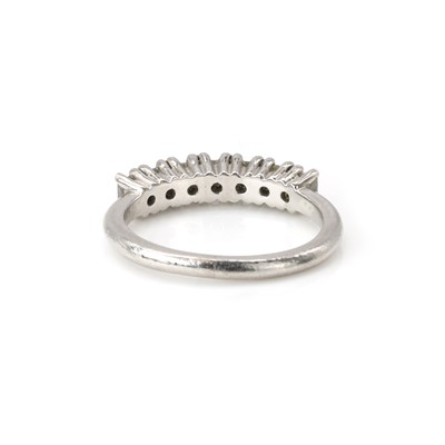 Lot 100 - A platinum and diamond half eternity ring
