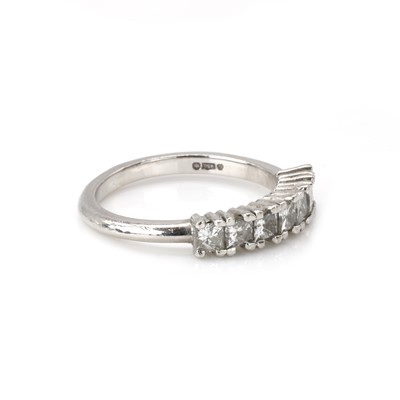 Lot 100 - A platinum and diamond half eternity ring
