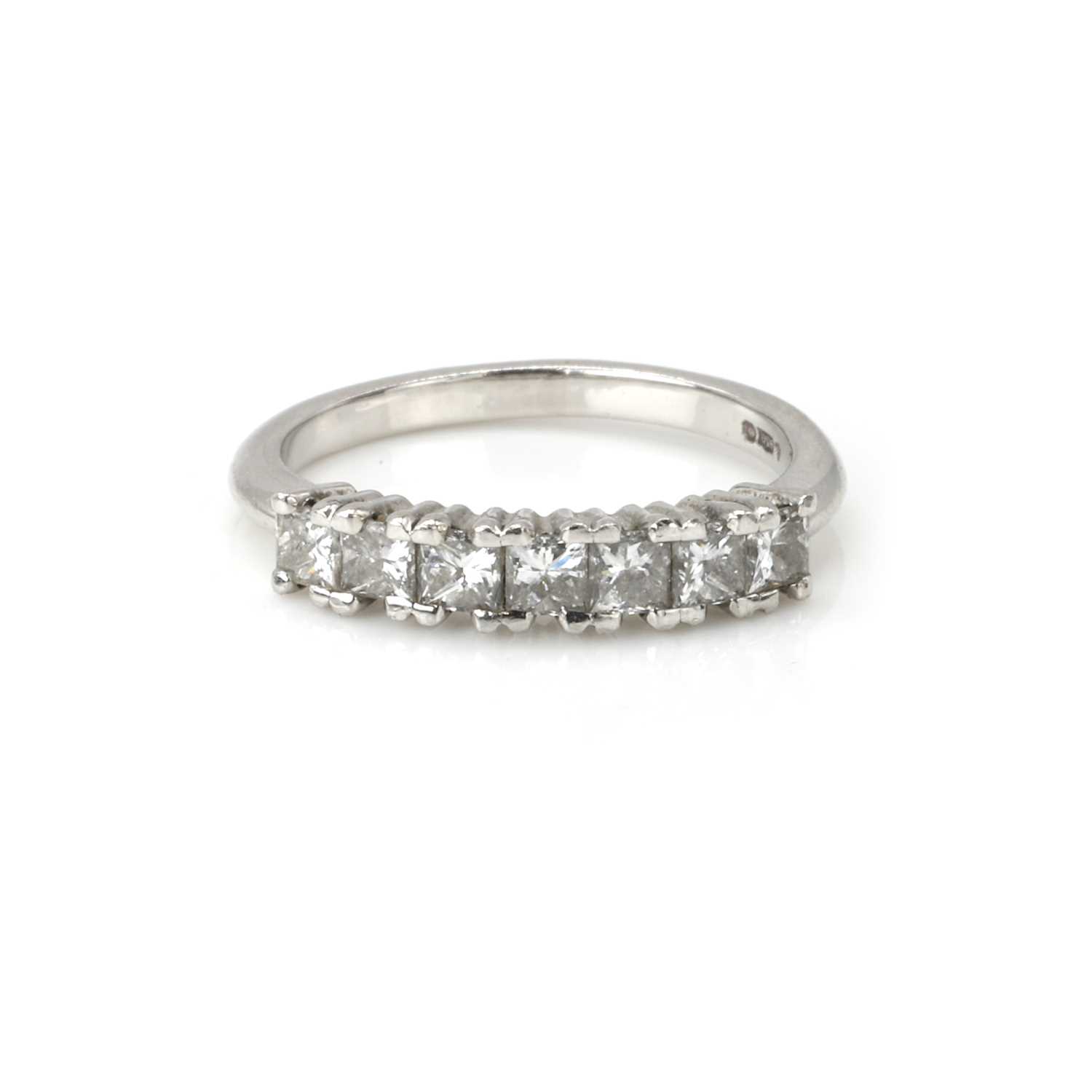 Lot 100 - A platinum and diamond half eternity ring