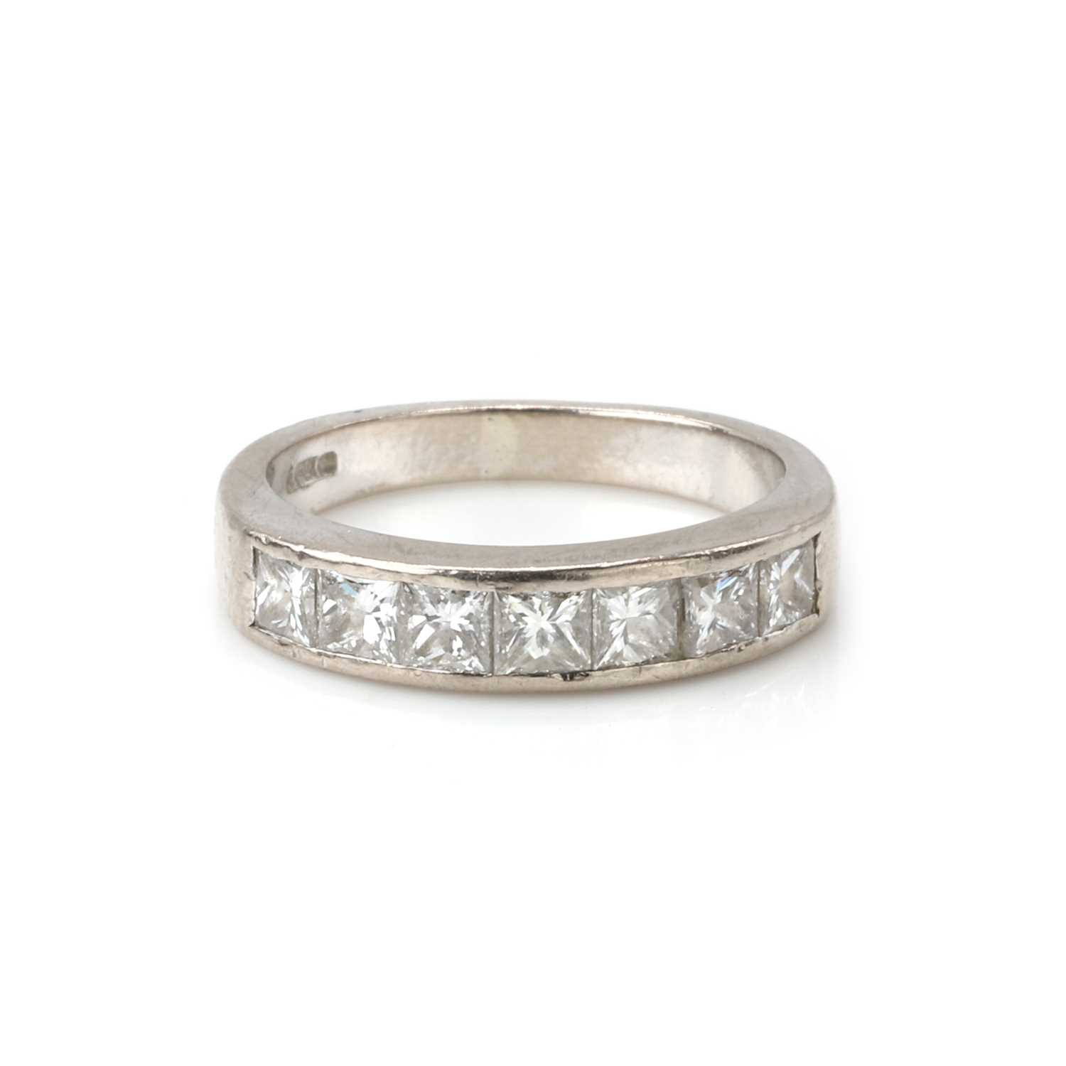 Lot 1080 - An 18ct white gold diamond half eternity ring