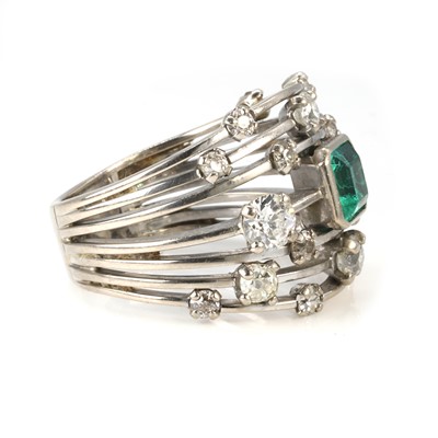 Lot 62 - An 18ct white gold emerald and diamond dress ring