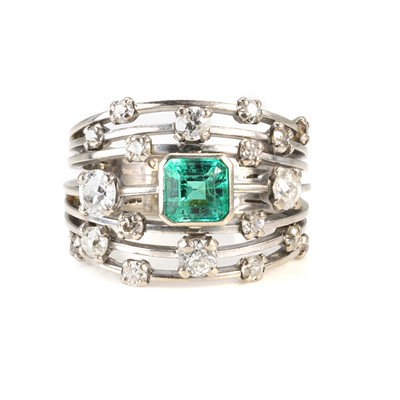 Lot 62 - An 18ct white gold emerald and diamond dress ring