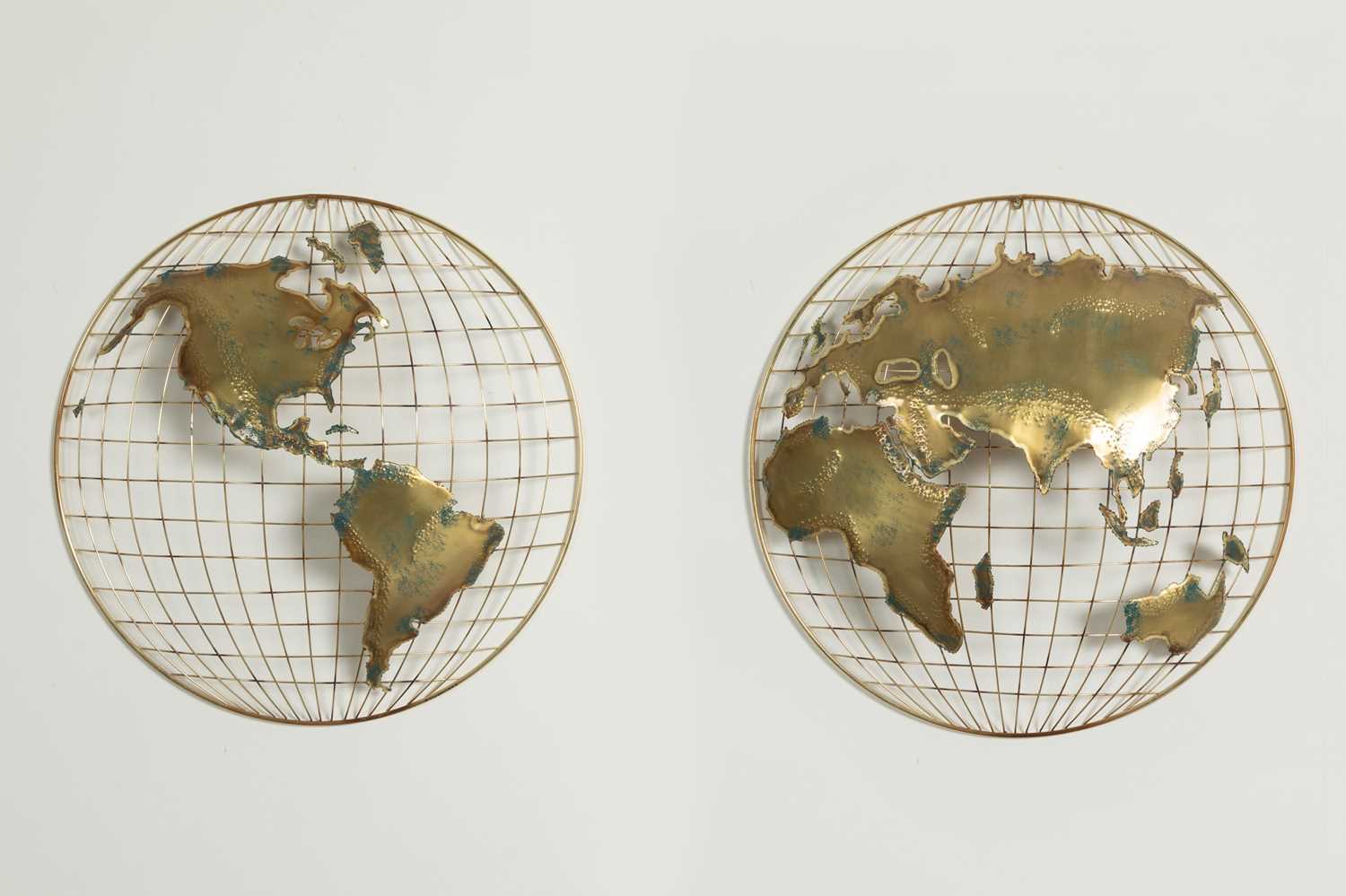 Lot 79 - A pair of brass and fret-cut wall-mounted 'world' sculptures