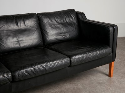 Lot 88 - A black leather three-seater settee