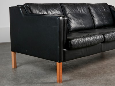 Lot 88 - A black leather three-seater settee
