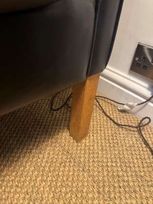 Lot 88 - A black leather three-seater settee