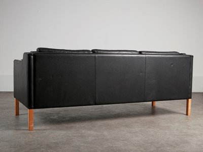 Lot 88 - A black leather three-seater settee