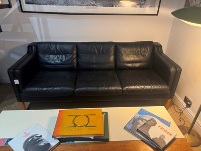 Lot 88 - A black leather three-seater settee