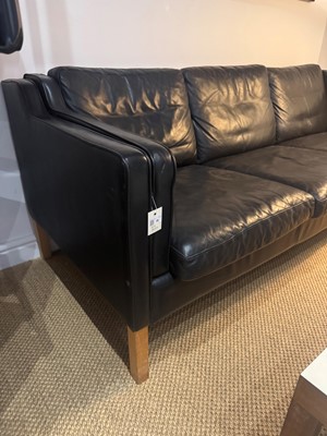 Lot 88 - A black leather three-seater settee