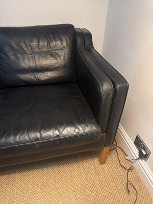 Lot 88 - A black leather three-seater settee