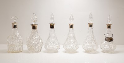 Lot 267 - A group of six silver-mounted cut glass decanters