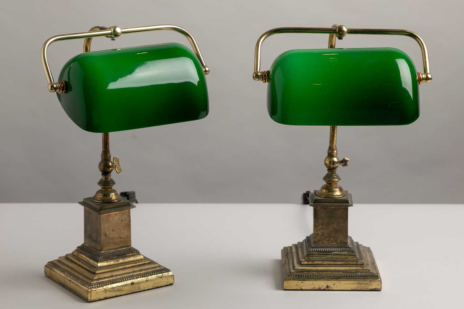 Lot 195 - A pair of brass and cased-glass desk lamps