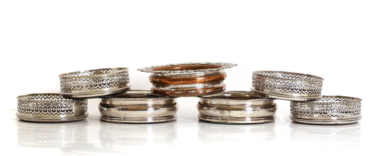 Lot 42 - A set of four George III silver wine coasters