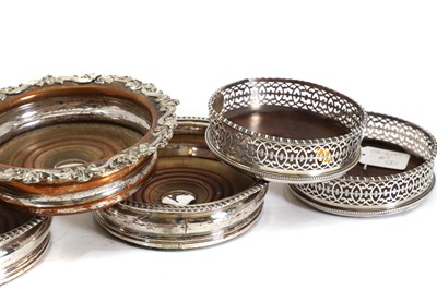 Lot 42 - A set of four George III silver wine coasters