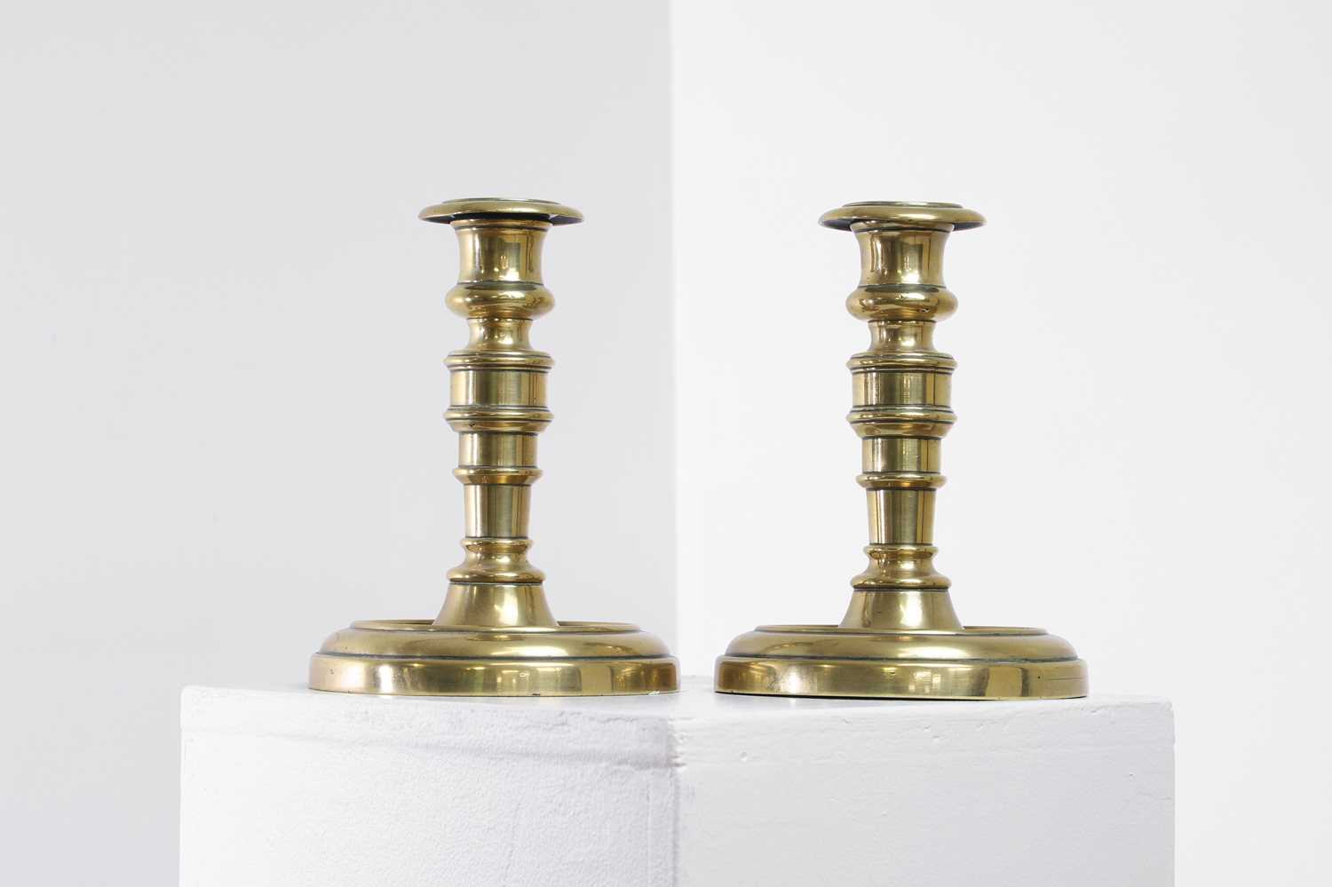 Lot 305 - A pair of George IV brass candlesticks