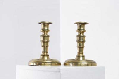 Lot 305 - A pair of George IV brass candlesticks