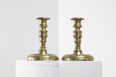 Lot 305 - A pair of George IV brass candlesticks