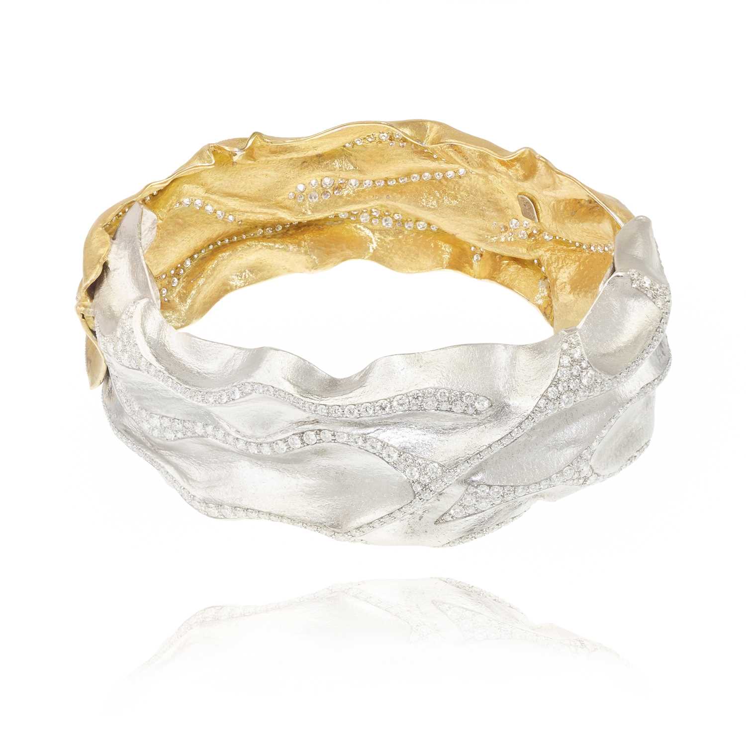 Lot 252 - Ken Bolan and Marinette Domon: a two-tone gold diamond 'Touche de Soie' bangle