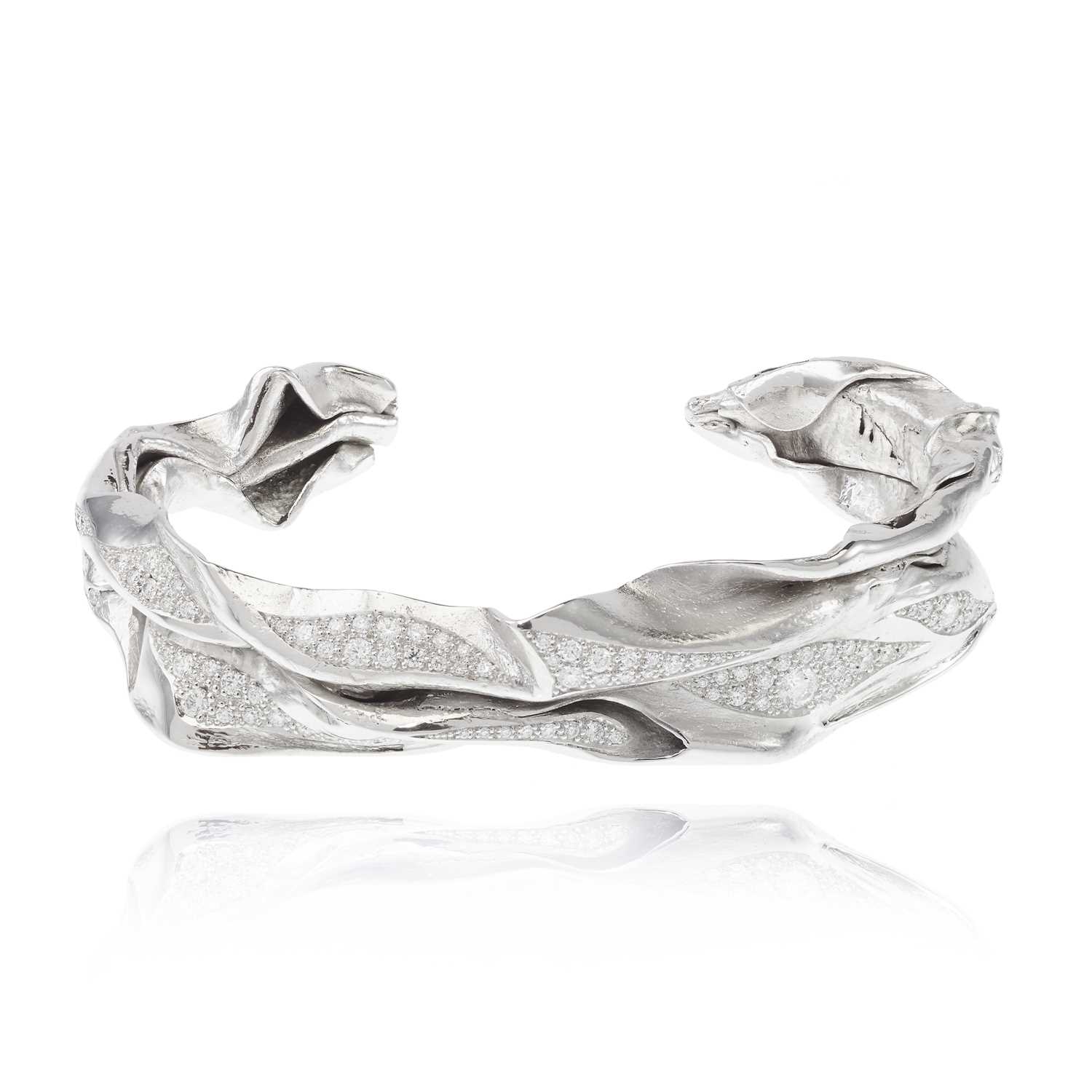 Lot 255 - Ken Bolan and Marinette Domon: a white gold diamond 'Touche de Soie' bangle