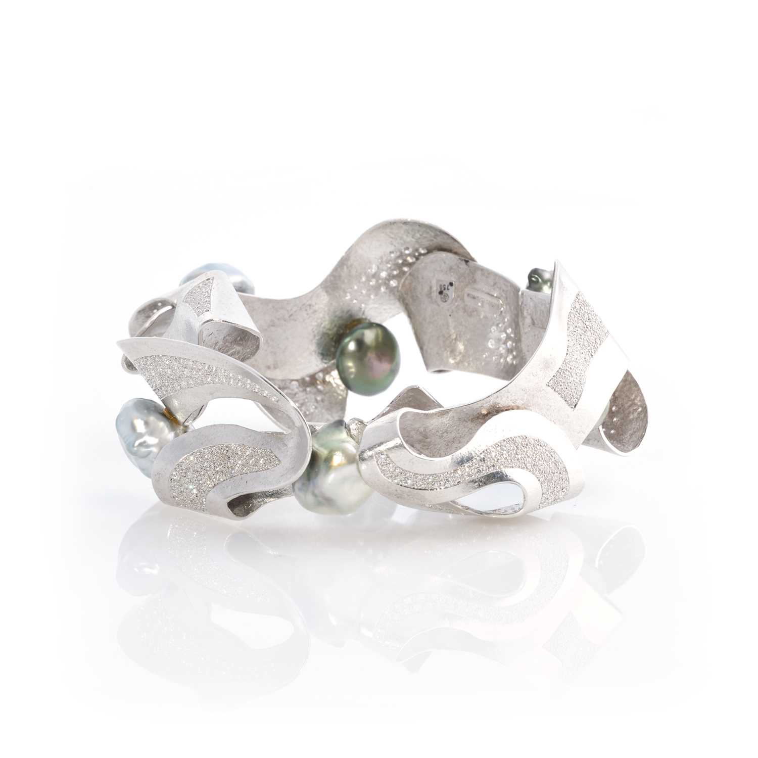 Lot 269 - Ken Bolan and Marinette Domon: a white gold, Tahitian pearl and diamond 'Baroque' bangle
