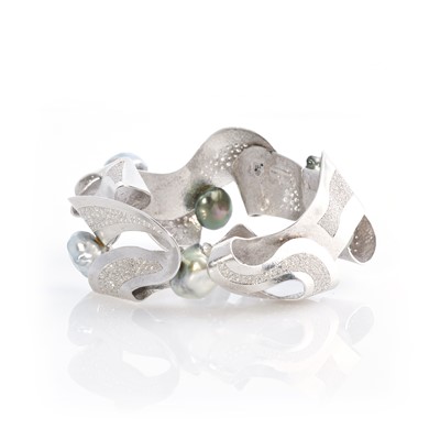 Lot 269 - Ken Bolan and Marinette Domon: a white gold, Tahitian pearl and diamond 'Baroque' bangle